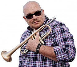 Farnell Newton is a trumpeter, teacher, bandleader of The Othership Connection, record label head and father of five.