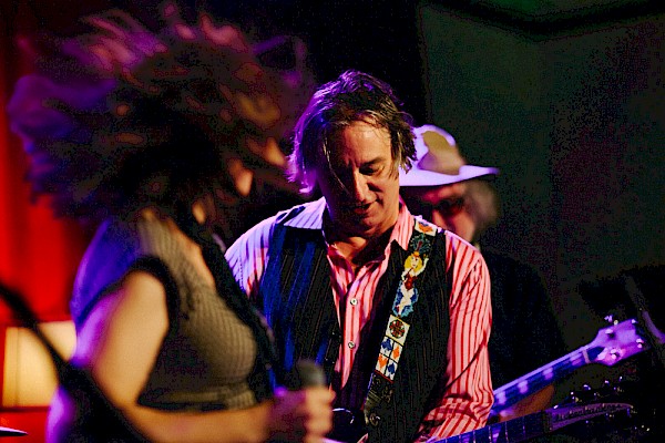 Peter Buck, with Sleater-Kinney's Corin Tucker in the foreground and Scott McCaughey of The Minus 5 and Young Fresh Fellows behind, opening for himself in 2014 as part of the supergroup that would become Filthy Friends—click to see more photos by Jason Quigley