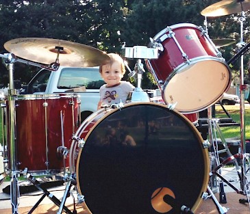 The budding drummer Isaac at a summertime School of Rock show. Photo by Annette Johnson