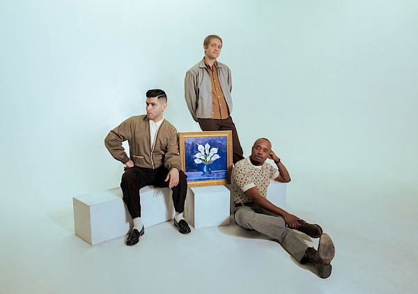 The core trio of Aaron Frazer, Blake Rhein and Durand Jones with the painting of calla lilies—which are full of “symbolism around growth and rebirth,” according to Rhein—that appears on the cover “Flowers”: Photo by Kalie Johnston